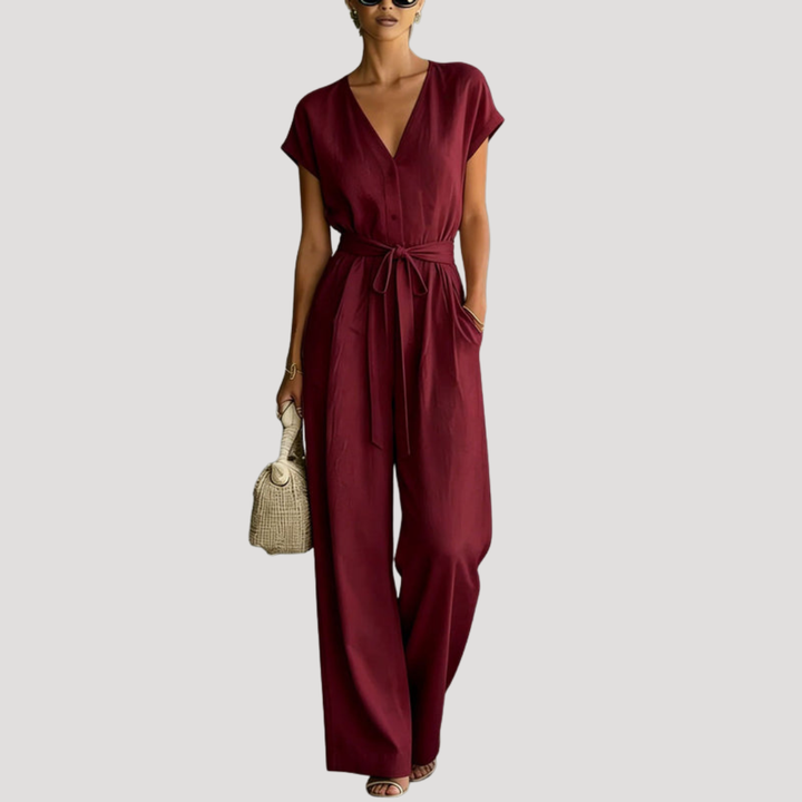 Fashionable women's v-neck cap sleeve wide leg jumpsuit with tie waist, offering easy elegant style.