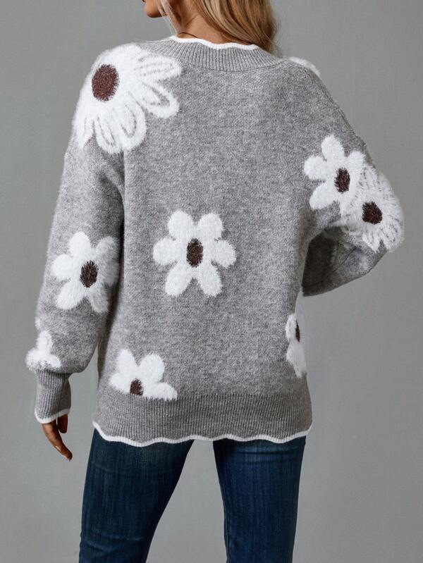 Close-up of a women's V-neck floral sweater showing textured appliqués. Comfortable and unique casual top.