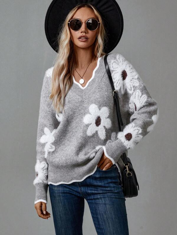 Stylish women's V-neck jumper featuring a vibrant floral design and subtle textured appliqués. Perfect for fashion.
