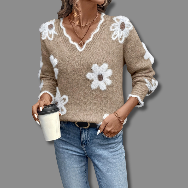Detailed view of textured floral appliqués on a women's V-neck long sleeve sweater. Cozy and unique pullover.