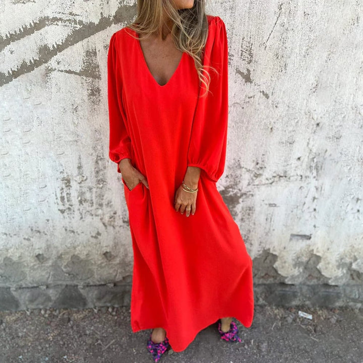 Comfortable women's long V-neck maxi dress, featuring stylish balloon sleeves & convenient pockets. Perfect for elegant summer evenings.