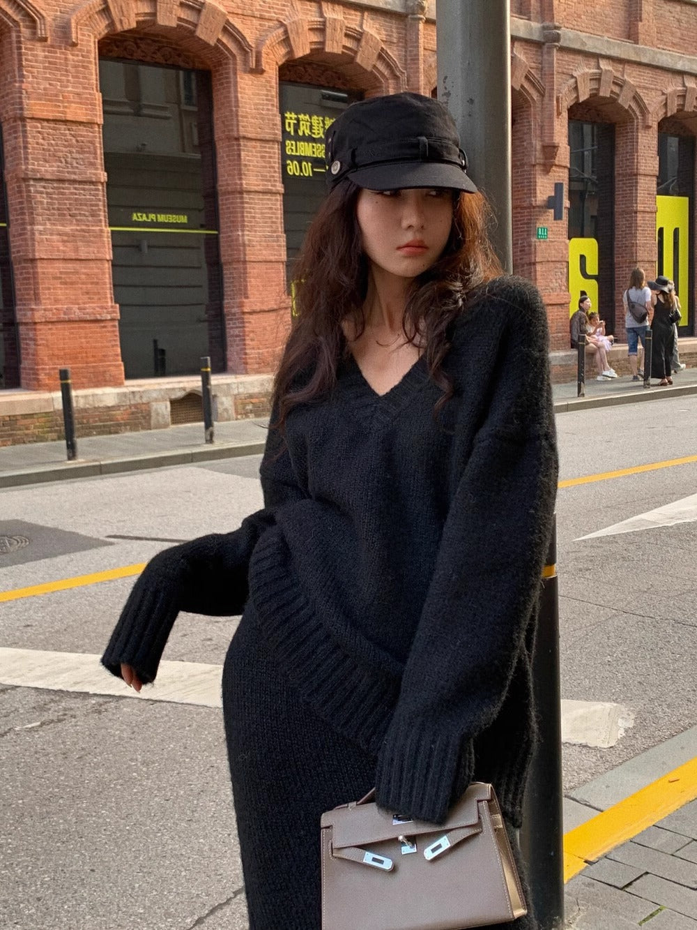 Soft knit women's V-neck long sleeve sweater and matching midi skirt set, ideal for comfortable wear.