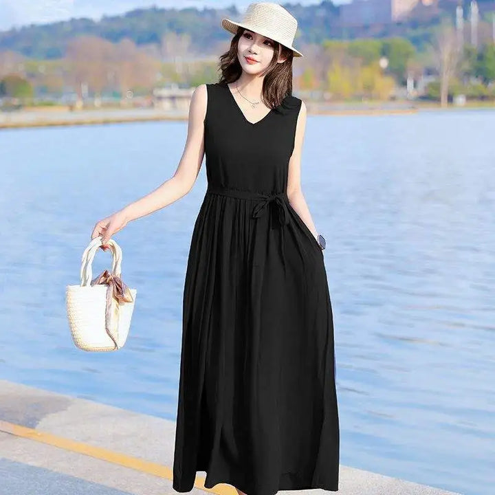 Flowy sleeveless V-neck maxi dress for women, featuring a stylish tie waist and practical pockets.