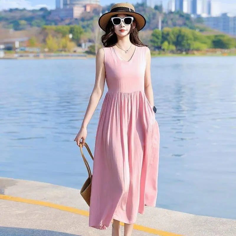 Flowy women's V-neck maxi dress, perfect for an elegant summer look. Features tie waist and practical pockets.