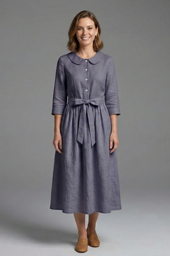 Model wearing a flattering women's V-neck midi dress with a chic waist tie. Elegant women's fashion.