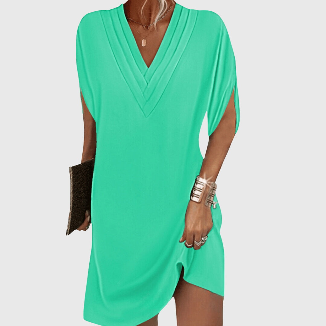 Stylish women's V-neck mini dress with draped short sleeves & relaxed cocoon fit, great for summer.