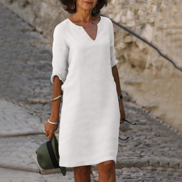 Elegant casual women's summer dress, V-neck, midi length, relaxed fit, three-quarter sleeves.