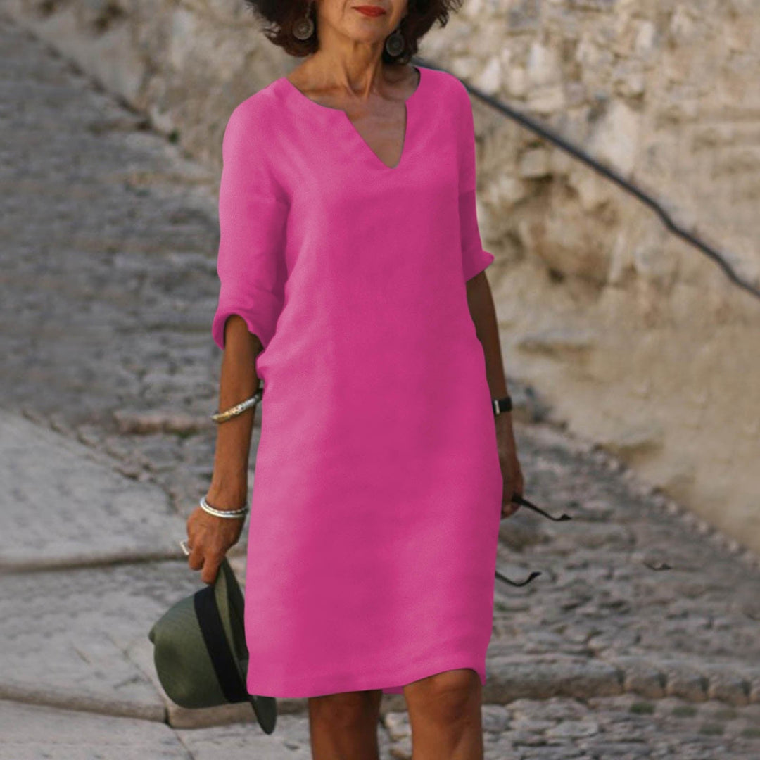 Chic women's V-neck summer dress, midi length with a relaxed, flattering fit.