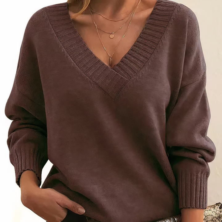 Soft knit women's long sleeve v-neck sweater, featuring a stylish ribbed design and relaxed fit.