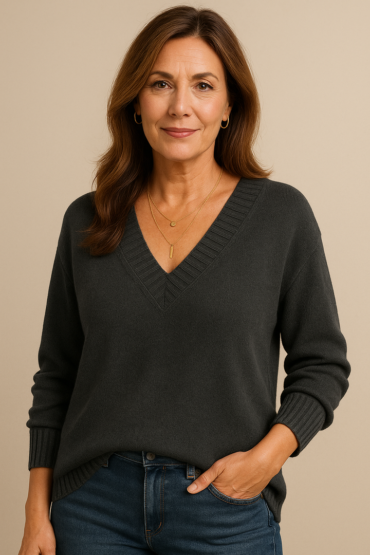 Full body shot of a woman in a relaxed fit v-neck ribbed long sleeve sweater. Casual fashion.