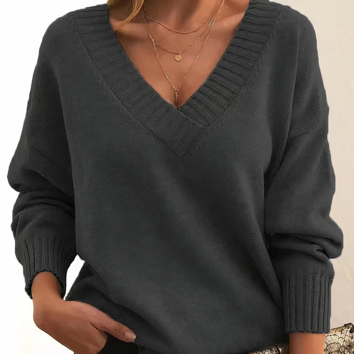 Model wearing a comfortable women's relaxed fit v-neck ribbed long sleeve sweater.