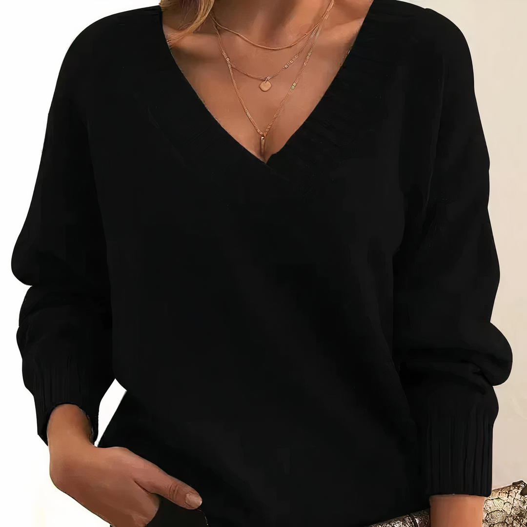 Textured ribbed women's sweater featuring a v-neckline and long sleeves for a cozy, relaxed fit.