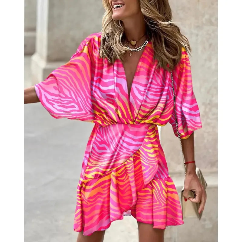 Women's V-neck ruffle mini dress with a vibrant abstract print, perfect for summer parties and casual wear.