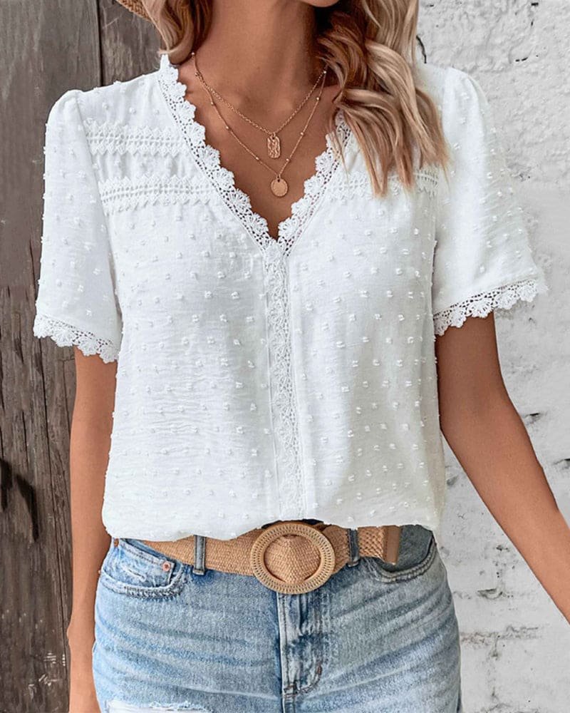 Women's V-neck Swiss Dot top with delicate lace trim. Short sleeve, relaxed fit for casual spring/summer style.