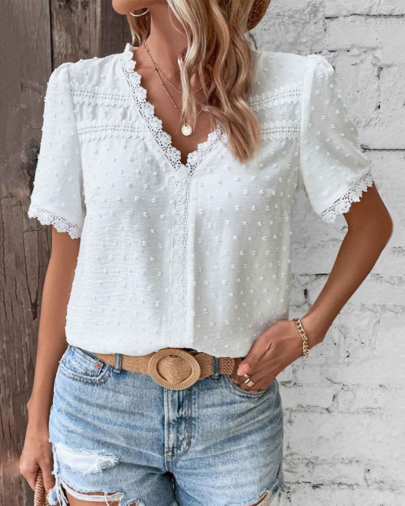 Boho style women's V-neck Swiss Dot blouse, perfect for summer. Features short sleeves & elegant lace trim.