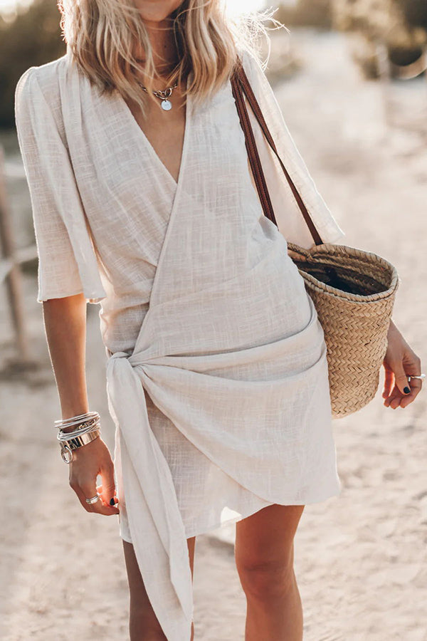 Women's V-neck tie-waist short-sleeve wrap mini dress, ideal for summer casual wear or vacation.