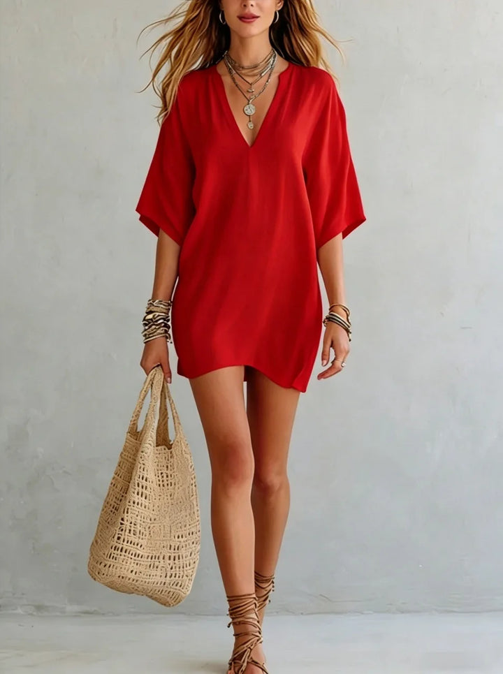 Effortless women's V-neck mini tunic dress with a relaxed fit. Perfect for casual summer beach days.