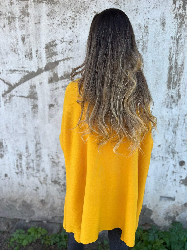 Women's relaxed fit v-neck jumper, an oversized tunic sweater with batwing sleeves for comfort.