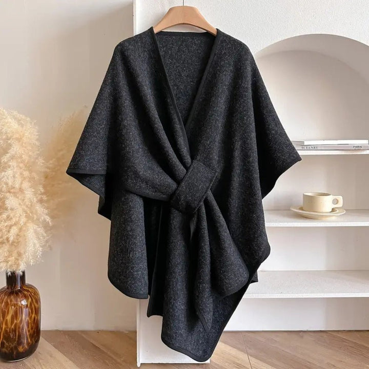 Fashionable women's versatile outerwear poncho, styled as a comfortable scarf wrap coat for all-season elegance.