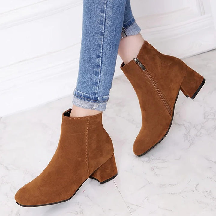 Women's versatile black ankle boots with stable block heel and convenient side zip, perfect for everyday wear.