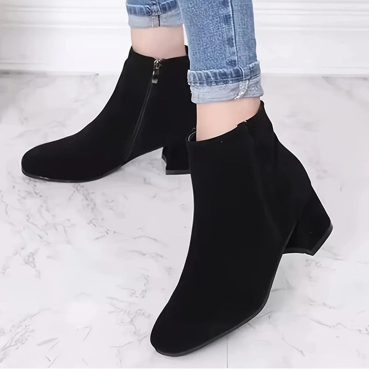 Comfortable women's ankle boots with stable block heel & side zip. Versatile footwear for all-day wear.