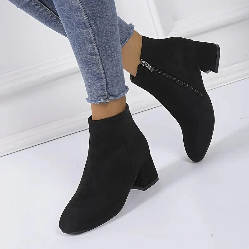 Elegant women's ankle boots feature a sturdy block heel and practical side zip, great for casual outfits.