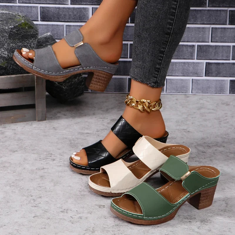 Chic women's leather sandals with comfortable block heels, ideal for versatile casual or elegant summer looks.