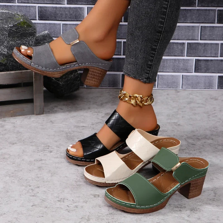 Chic women's leather sandals with comfortable block heels, ideal for versatile casual or elegant summer looks.