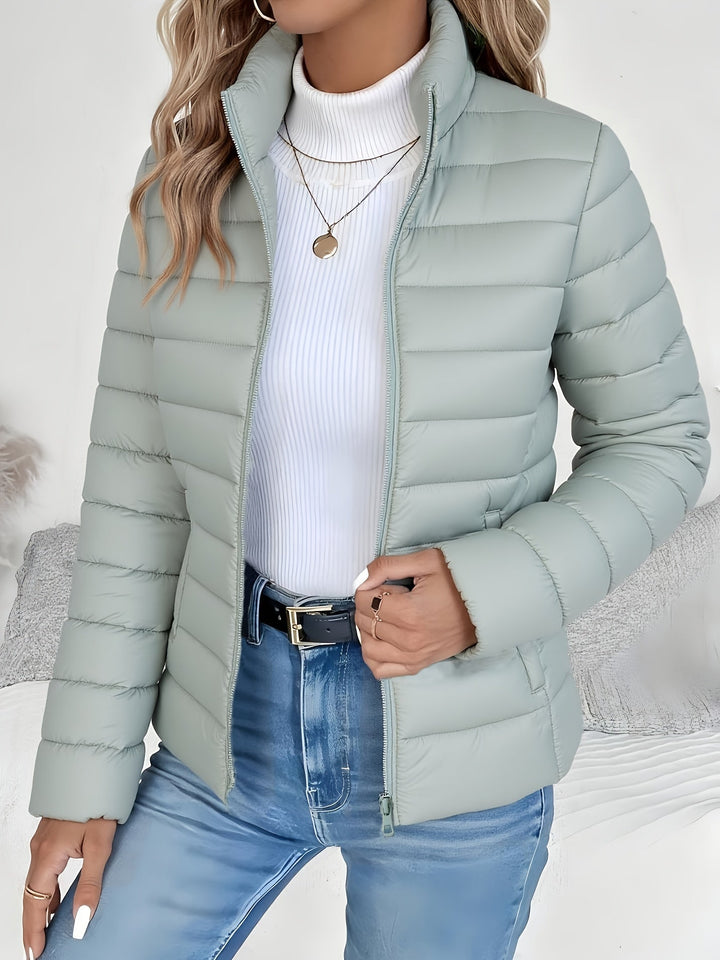 Women's versatile quilted jacket with a stand collar and zip closure, perfect for winter and fall outerwear.