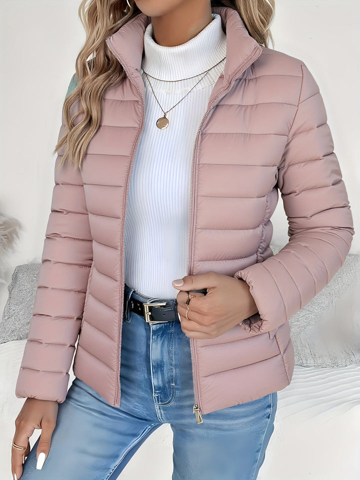 Slim-fit women's quilted jacket with a stand collar, offering casual style and lightweight warmth for everyday wear.