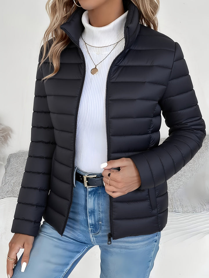 Lightweight women's quilted jacket, ideal for fall and winter. Features a stand collar and zip for versatile outerwear.