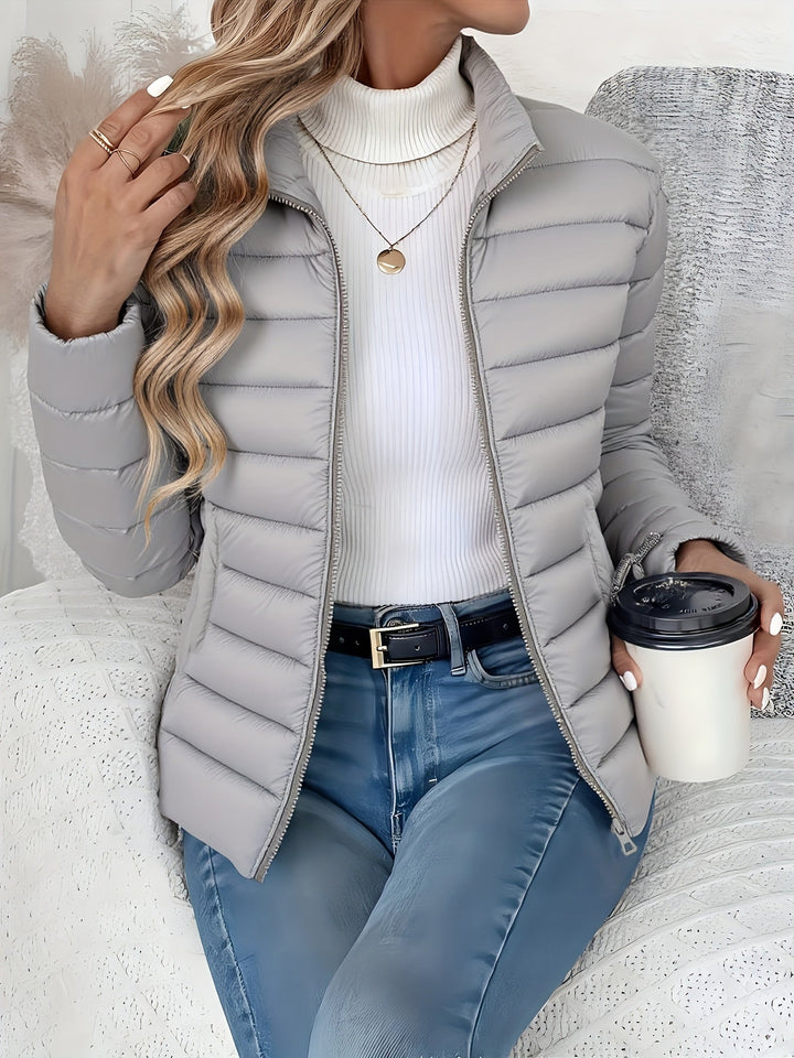 Casual women's quilted jacket featuring a stylish stand collar, full zip closure, and slim fit for winter fashion.