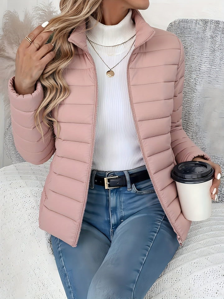 Versatile women's quilted jacket with a stand collar, zip closure, and slim fit, perfect for casual fall & winter.