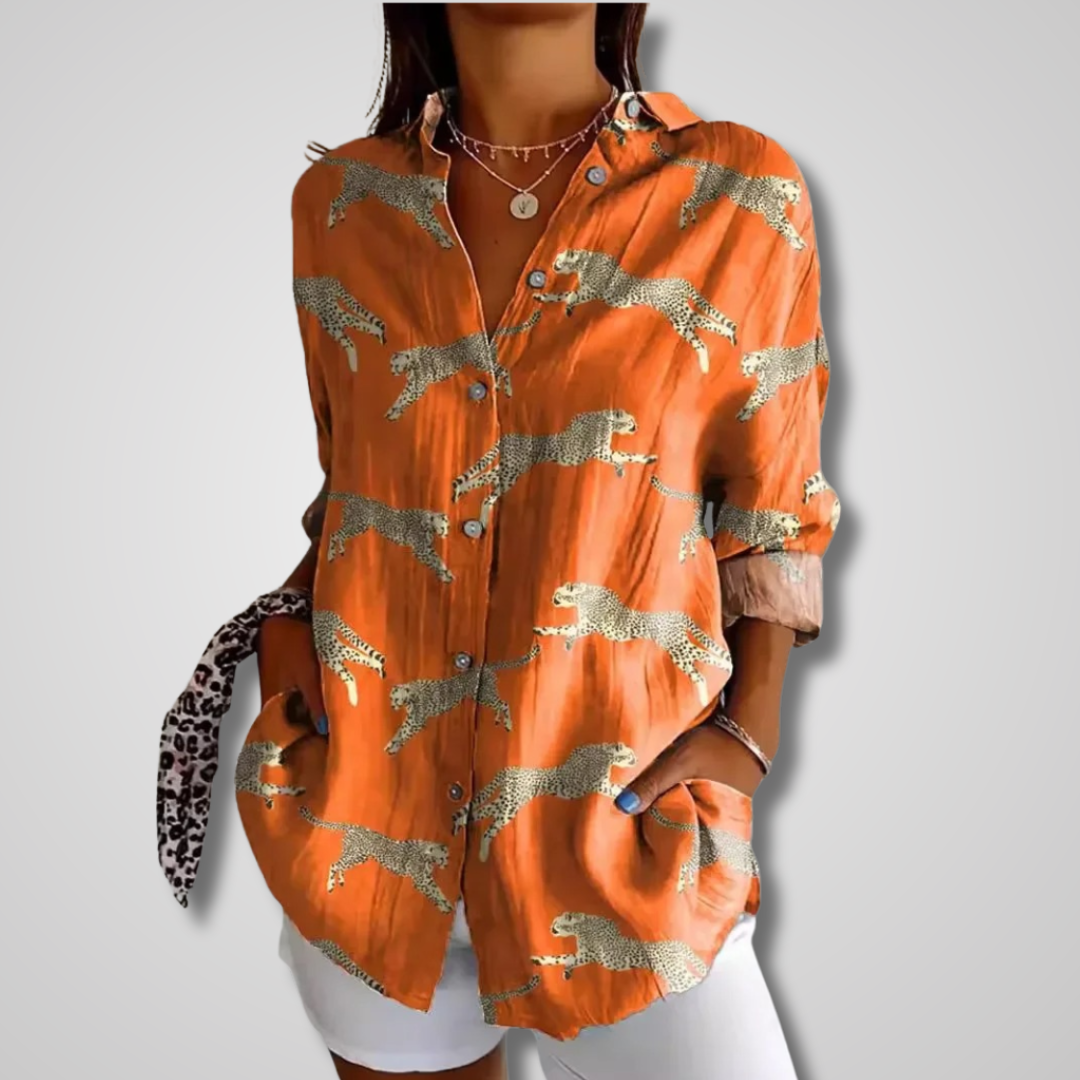 Oversized women's bohemian fashion top with artistic print, long sleeves, and a stylish v-neck design.