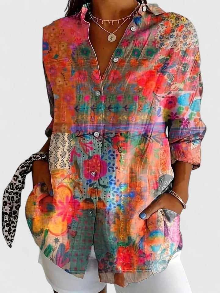 Flowy women's long sleeve blouse featuring a colorful floral abstract print, perfect for fashion.