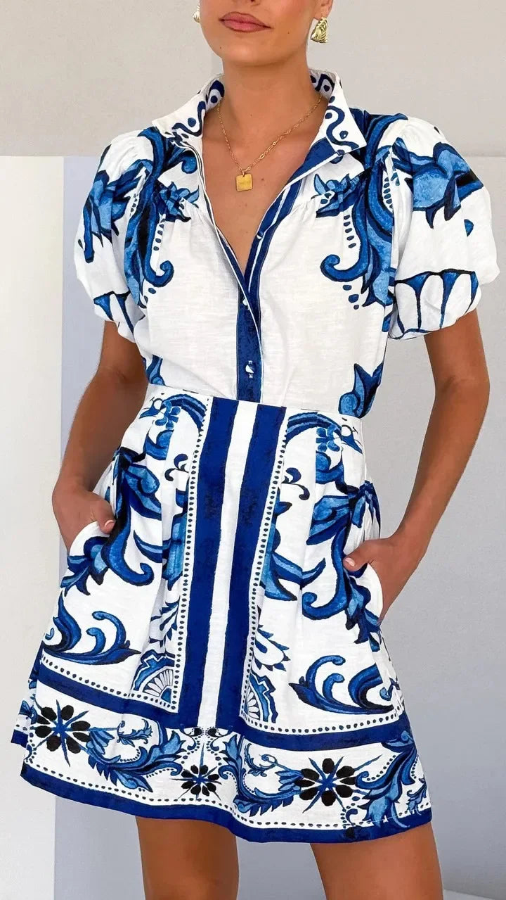 Chic women's floral cocktail dress with puff sleeves, flattering modern design.