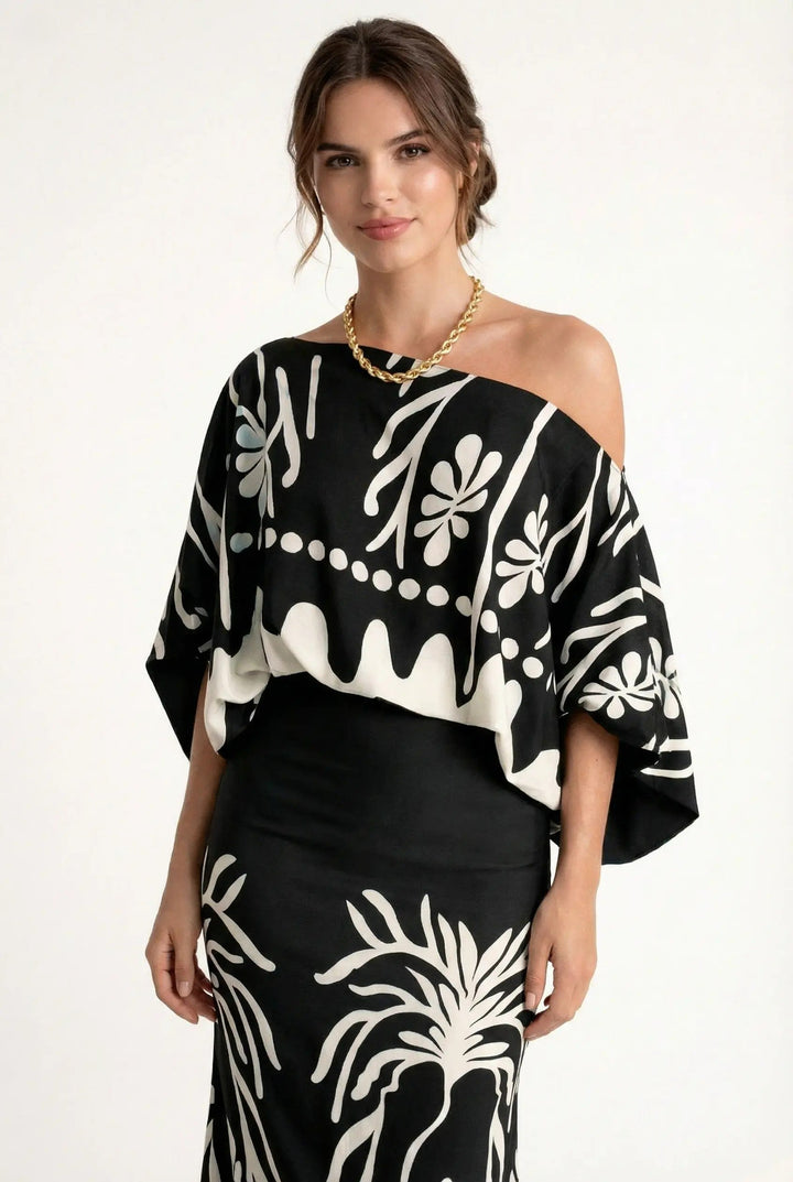 Elegant women's summer vacation set: a colorful printed blouse with a flowing maxi skirt, ideal for warm weather.