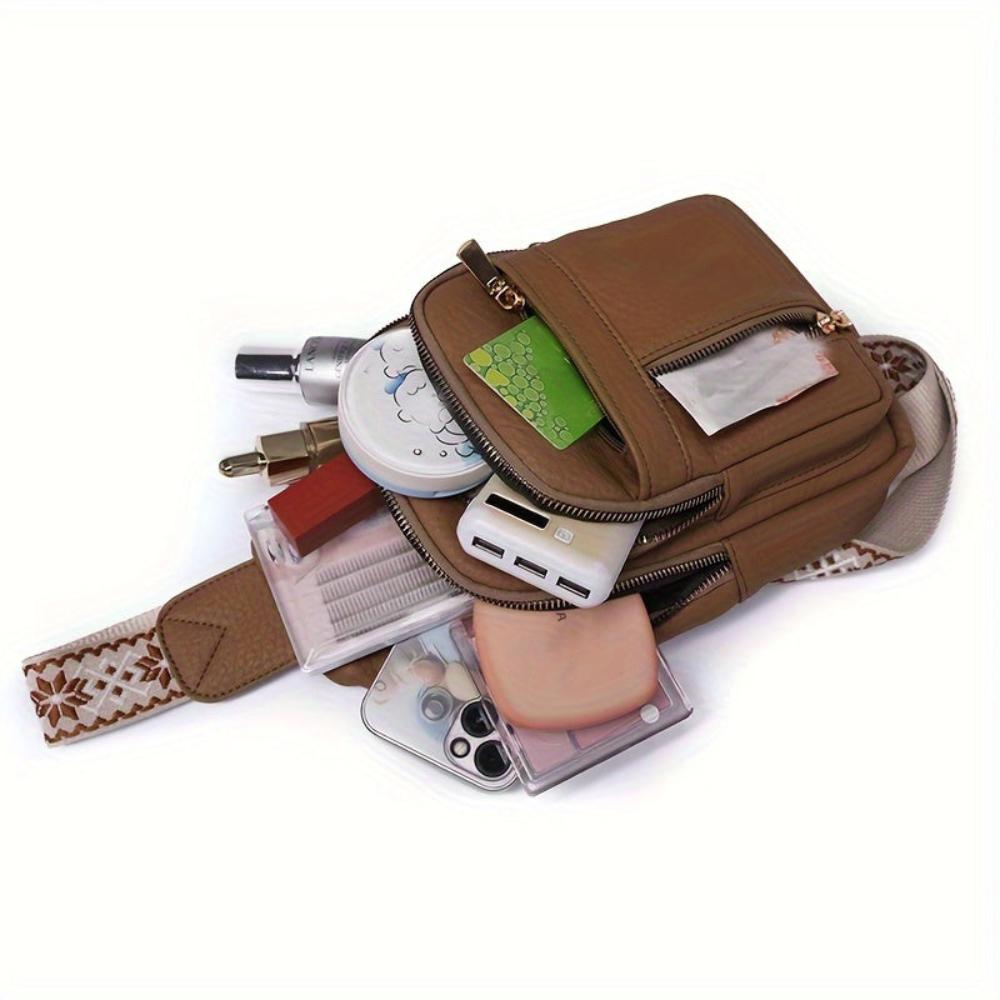Women's black vintage leather crossbody, fashionable chest bag for modern retro style.