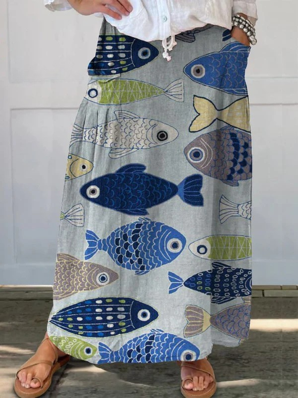 Women's vintage blue A-line midi skirt with playful fish art print and practical pockets, perfect for casual summer style.