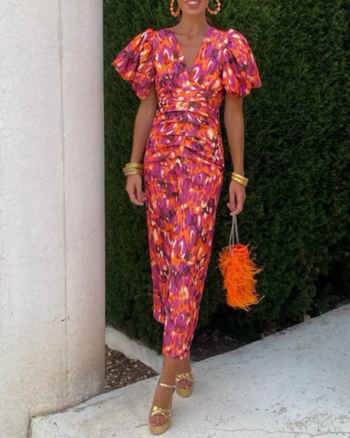 Women's vivid ruched midi dress with abstract print, perfect for elegant cocktail parties or special occasions.