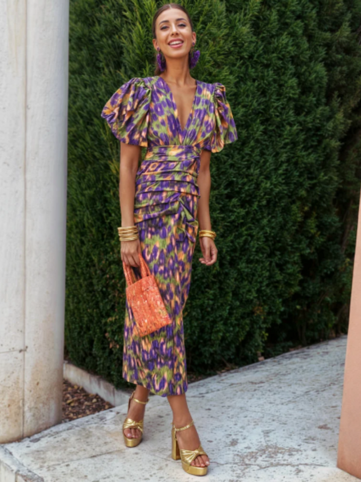 Modern women's ruched midi dress, featuring a vivid abstract print & statement style for elegant spring outings.