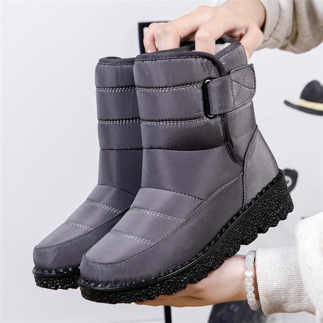 Stylish women's winter boots, waterproof & padded for warmth and comfort in cold weather.