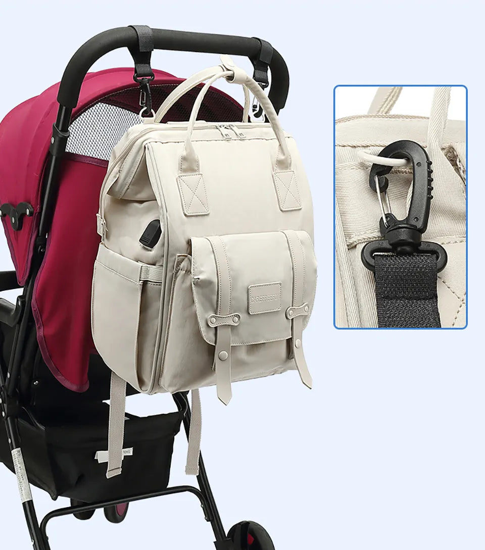 Diaper backpack hanging on a stroller, convenient for baby transport and errands.