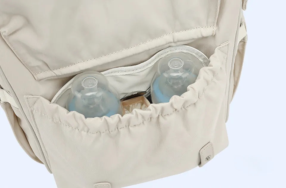 Diaper backpack with dedicated pocket for wet clothes, great for baby transport.