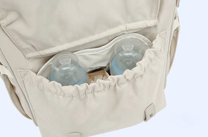 Diaper backpack with dedicated pocket for wet clothes, great for baby transport.