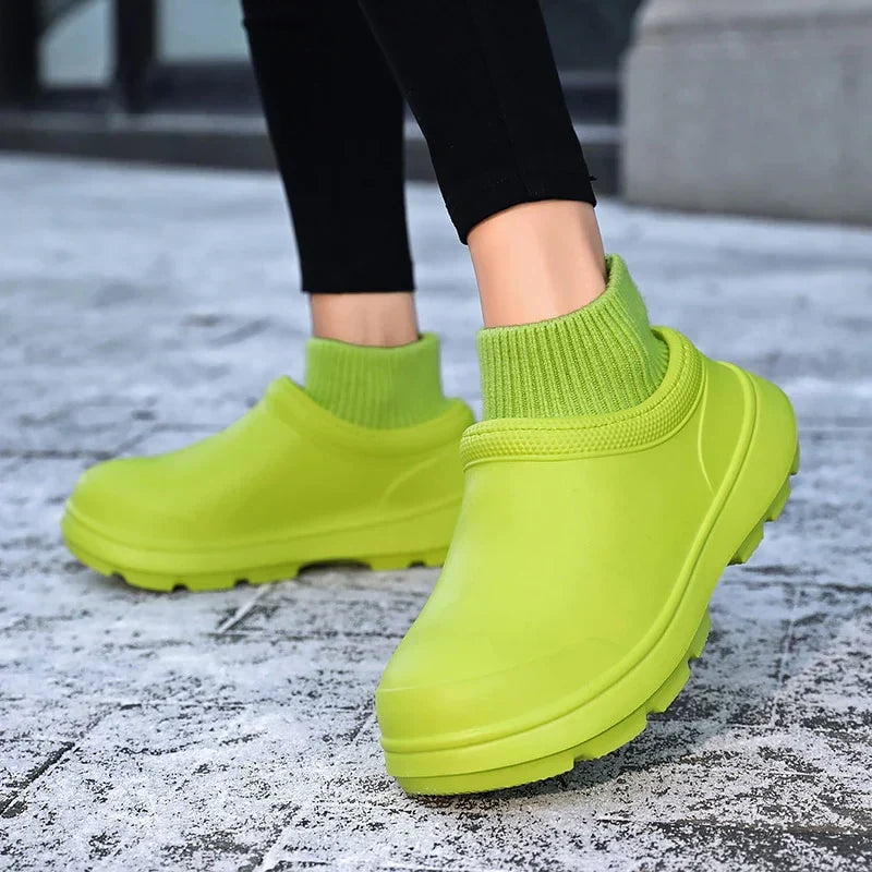 Protective women's waterproof clogs with a fashionable knit ankle cuff, offering comfort & casual style.