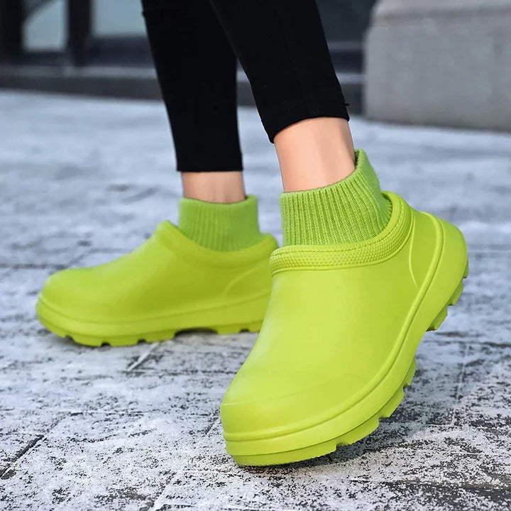 Protective women's waterproof clogs with a fashionable knit ankle cuff, offering comfort & casual style.
