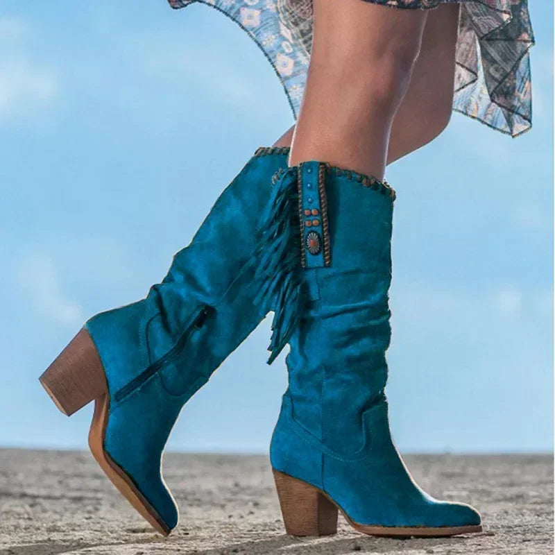 Bohemian-style women's western mid-calf boots with turquoise fringe, stud accents, and a sturdy block heel.
