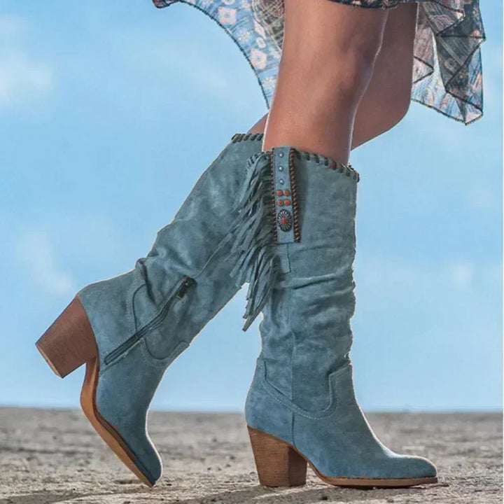 Women's turquoise fringe western mid-calf boots with stud accents, perfect for a chic cowgirl or boho look.