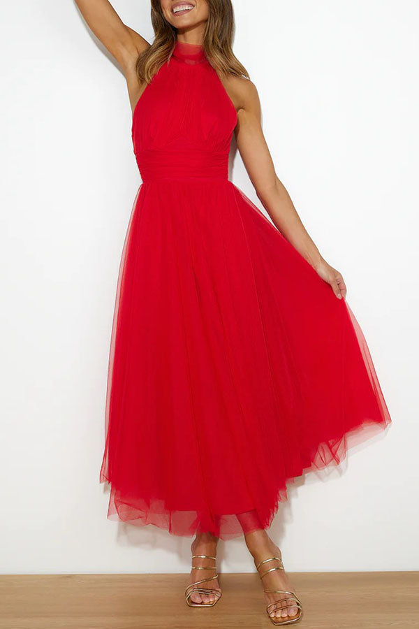 Woman wearing a vibrant, whimsical tulle midi dress, perfect as a wedding guest or for a special occasion party.